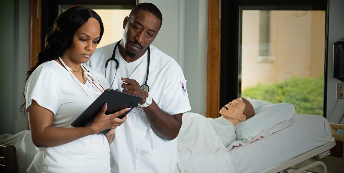 Trocaire nursing students reviewing a patient’s medical chart.