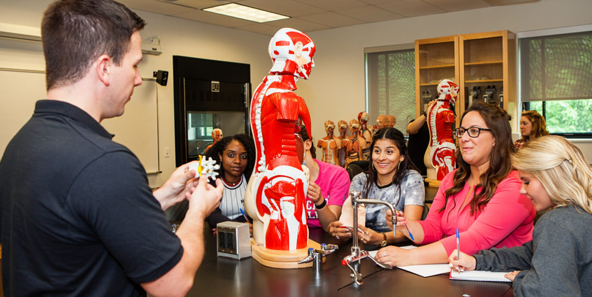 Students leaning in interactive classroom