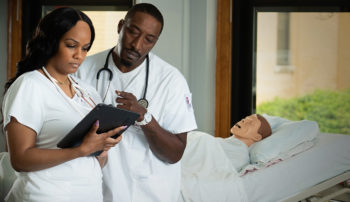 Trocaire nursing students reviewing a patient’s medical chart.
